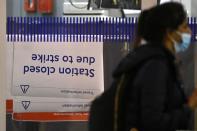 Rail passengers travel ahead of a planned national rail worker strike, in London
