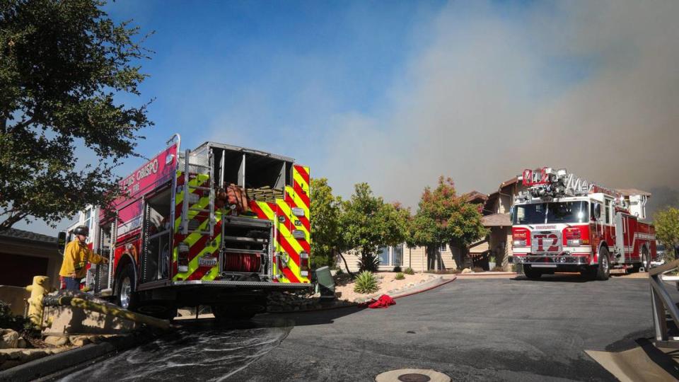 San Luis Obispo City firefighters stage for structure protection on Lizzie Street while battling a quick-moving fire in the hills above San Luis High School on Oct. 30, 2023.