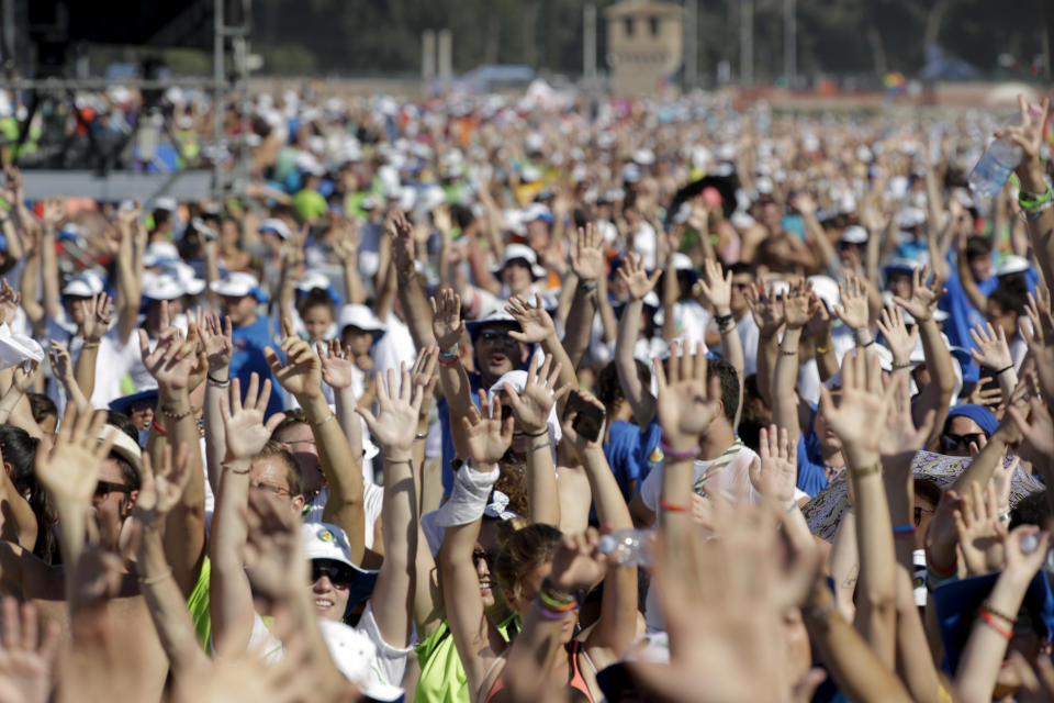 Faithful gather in Rome's Circus Maximus as they wait for the arrival of Pope Francis to lead an evening prayer vigil with youths, Saturday, Aug. 11, 2018. Thousand of youths gathered for the meeting with the pontiff in preparation for the next World Youth Day that will be held in Panama next year. (AP Photo/Andrew Medichini)