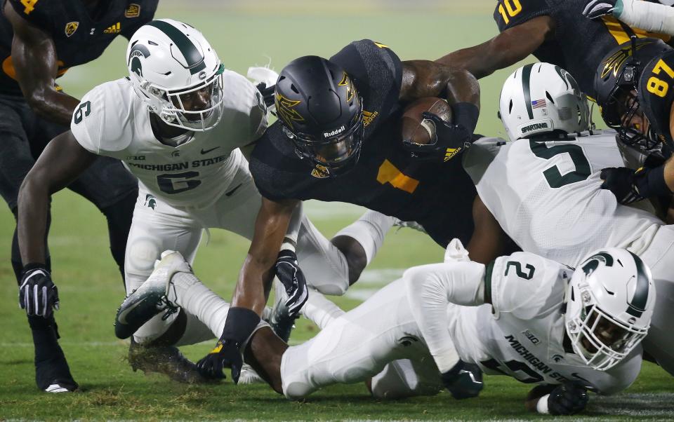 Arizona State wide receiver N'Keal Harry (1) is taken down by Michigan State safety David Dowell (6), cornerback Justin Layne (2) and linebacker Andrew Dowell (5) during the first half of an NCAA college football game Saturday, Sept. 8, 2018, in Tempe, Ariz. (AP Photo/Ross D. Franklin)