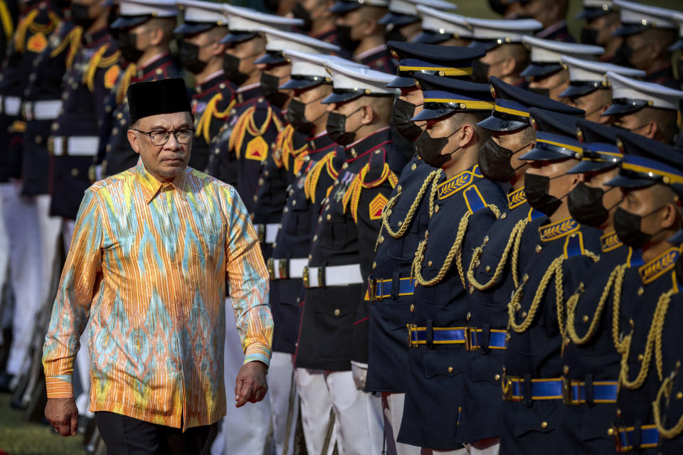 Malaysian Prime Minister Anwar Ibrahim reviews honor guards during a welcome ceremony at Malacanang Palace in Manila, Philippines, Wednesday March 1, 2023. Anwar Ibrahim is in Manila to hold talks with President Marcos in an effort to boost bilateral ties between the two countries. (Ezra Acayan/Pool via AP)