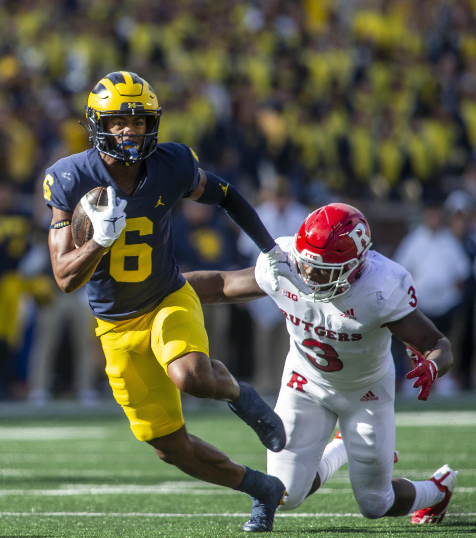 Michigan wide receiver Cornelius Johnson (6) rushes after a 23-yard reception while defended by Rutgers linebacker Olakunle Fatukasi (3) in the second quarter of an NCAA college football game in Ann Arbor, Mich., Saturday, Sept. 25, 2021. (AP Photo/Tony Ding)
