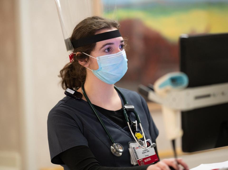 Christina Brahos, a 24-year-old nurse who began working at UW Hospital at the end of October, updates patient information at the hospital on May 6.