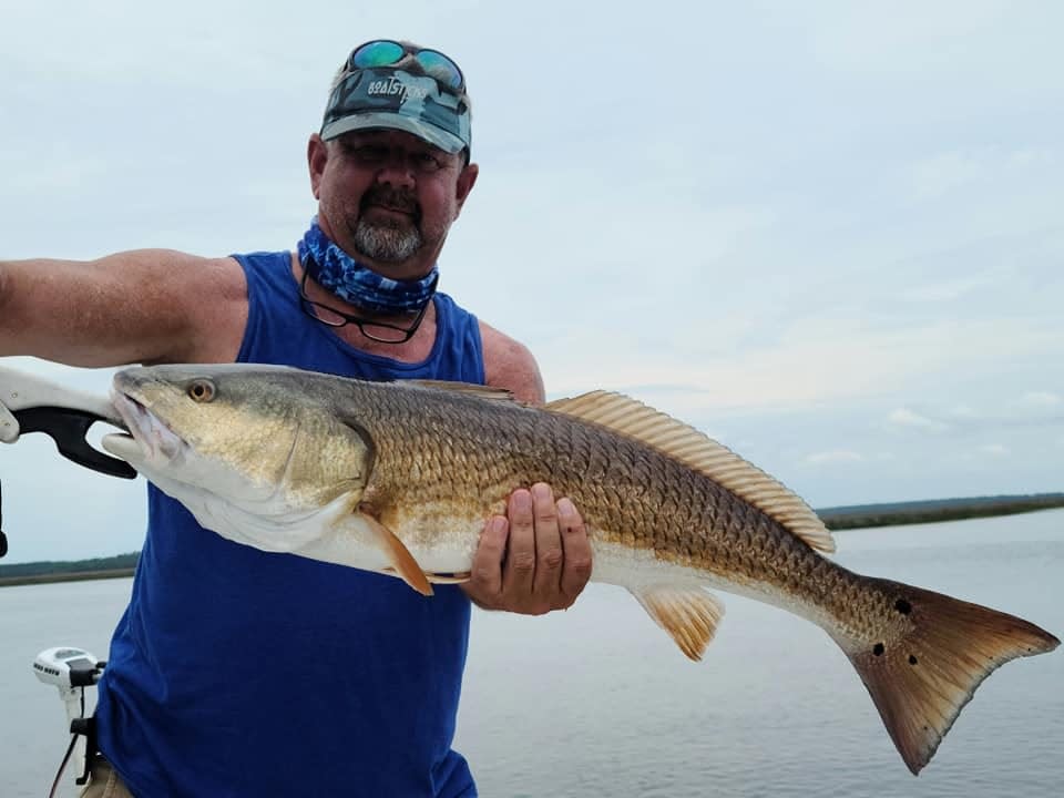 Cliff “JR” Mundinger holds an over-slot Redfish caught while targeting submerged oyster bars. 1 of several caught during tidal change.