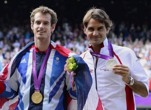 Andy Murray (left) and Roger Federer with their gold and silver medals after Murray beat the Swiss star in the Olympic final. Murray may have captured the US Open and Olympic titles, but he insisted Tuesday that Roger Federer and vanquished New York rival Novak Djokovic remain the standout players of 2012