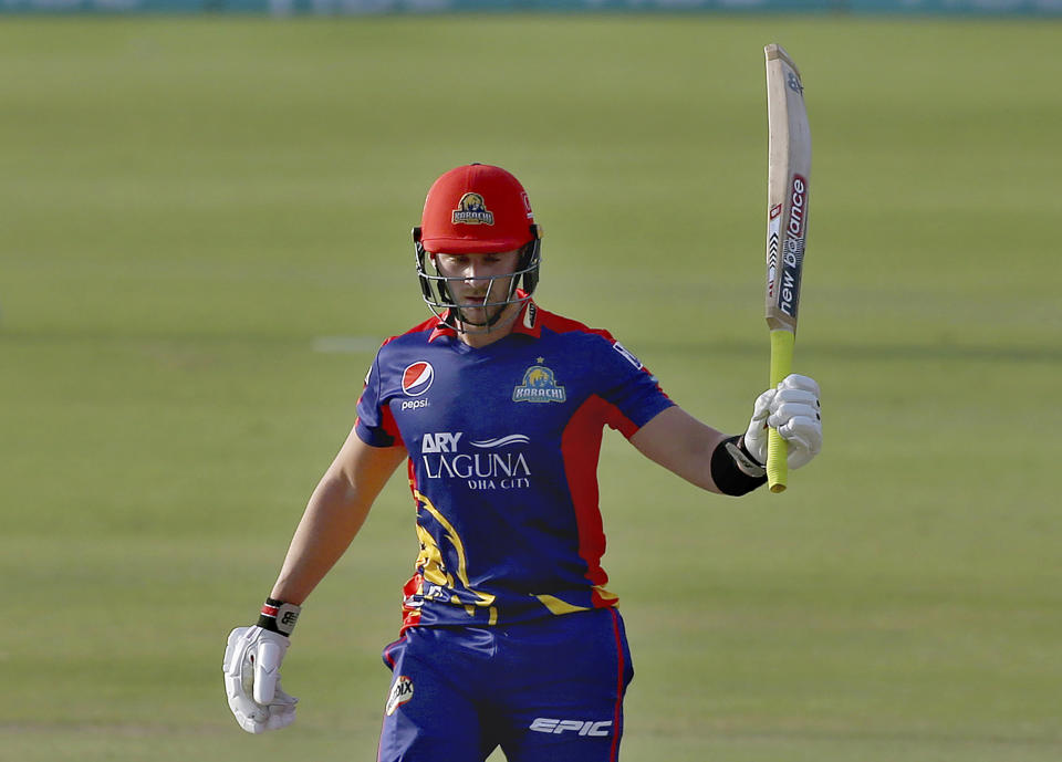 Karachi Kings' Joe Clarke raises bat to celebrate after scoring fifty during a Pakistan Super League T20 cricket match between Karachi Kings and Multan Sultans at the National Stadium, in Karachi, Pakistan, Saturday, Feb. 27, 2021. (AP Photo/Fareed Khan)