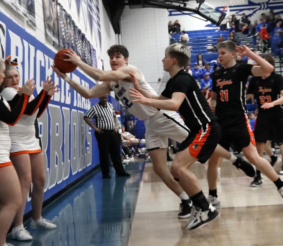 Buckeye Trail's Brady Hastings (12) moves quickly to keep the ball in play during the basketball game against Newcomerstown Tuesday evening at Buckeye Trail High School.