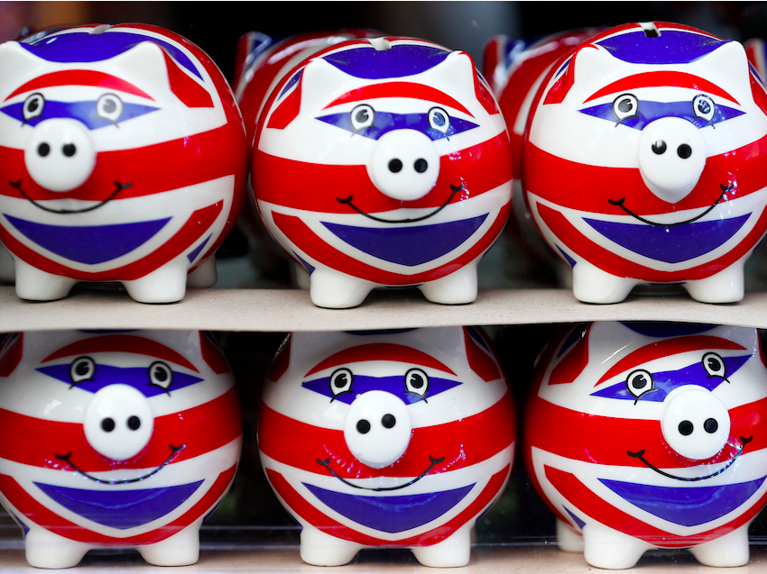 Smiling Union Jack piggy banks are lined up for sale in the window of a souvenir store on Oxford Street in central London January 20, 2014.