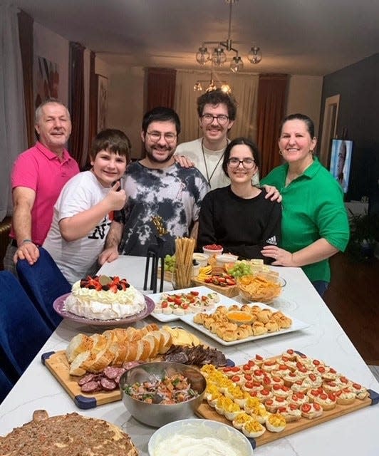 (From left) The Omeragic family – father Hajrudin, children Elhan, Ismar, Faris, and Ajla, and mother Mersiha – celebrate New Year's with a plentiful spread.