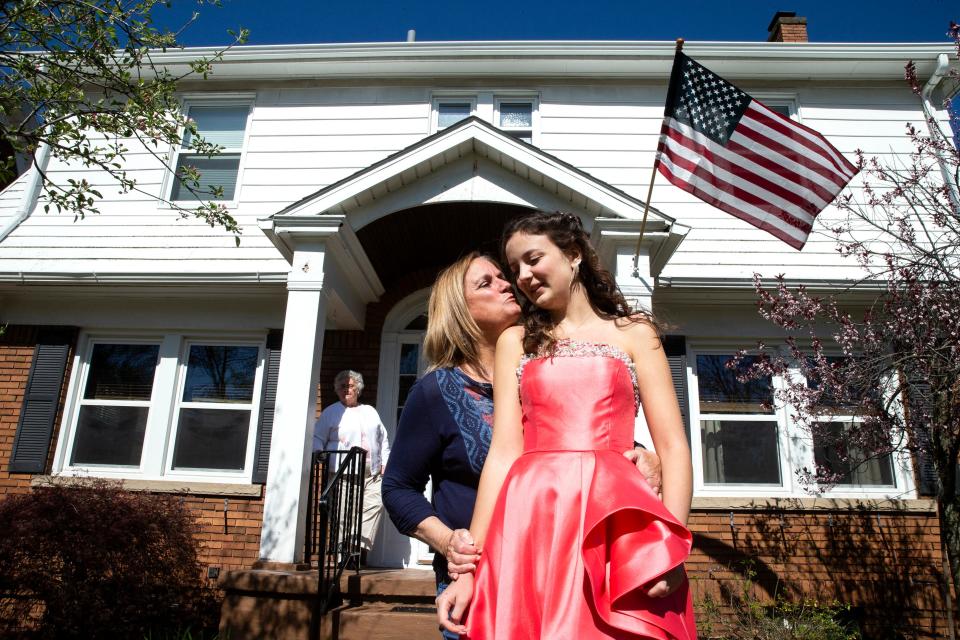 Mercyhurst Preparatory School Junior Sophia Potalivo, 17, receives a kiss from her grandmother, Betta Otto, 69, with grandma, Joan Talivo, 84, in the background, on May, 7, 2022, in front of their home in Erie. Sophia waits for her date to pick her up for the Mercyhurst Prep prom to be held that evening at the former Masonic building in Erie. 