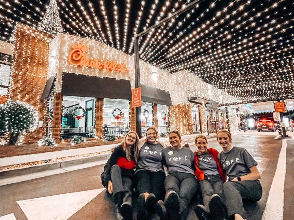 Staff pose in front of the Chick-fil-A Athens-Atlanta Highway