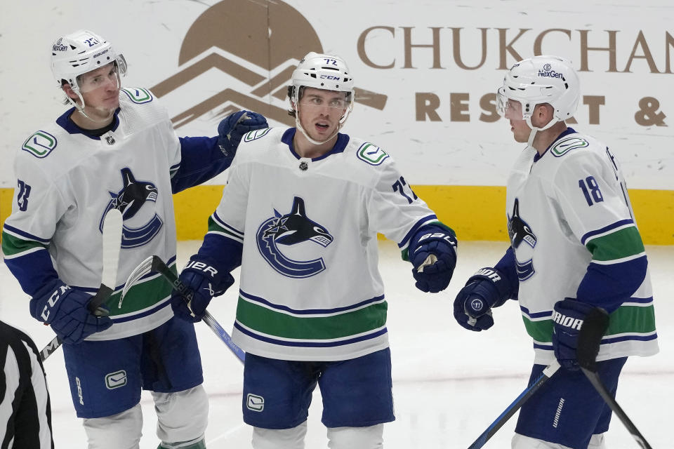 Vancouver Canucks left wing Anthony Beauvillier (72) is congratulated by center Jack Studnicka, left, and center Sam Lafferty (18) after scoring against the San Jose Sharks during the third period of an NHL hockey game in San Jose, Calif., Thursday, Nov. 2, 2023. (AP Photo/Jeff Chiu)