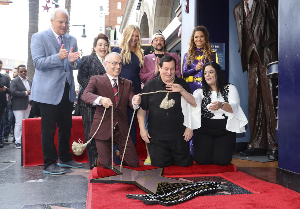 Jeff Zarrinnam, from left, Donelle Dadigan, Mitch O'Farrell, Nancy O'Dell, Burt Ward, Kevin Smith, Maria Menounos and Rana Ghadban unveil a star during a ceremony honoring Burt Ward with a star at the Hollywood Walk of Fame on Thursday, Jan. 9, 2020, in Los Angeles. (Photo by Willy Sanjuan/Invision/AP)