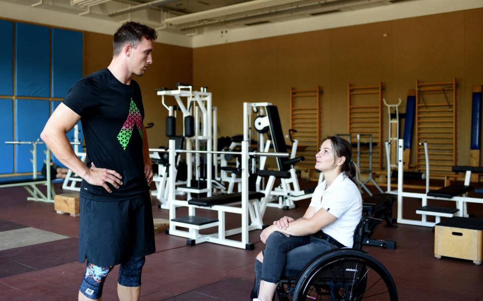 Kristina Vogel coaching an athlete in the gym  - Wolfgang Siesing