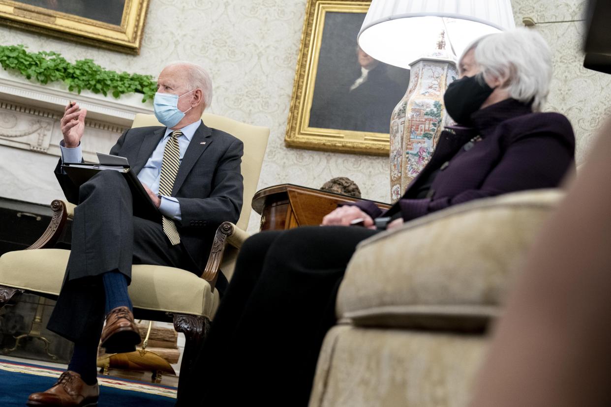 President Joe Biden, accompanied by Treasury Secretary Janet Yellen, right, speaks as he gets his weekly economic briefing in the Oval Office of the White House, Friday, April 9, 2021, in Washington. (AP Photo/Andrew Harnik)