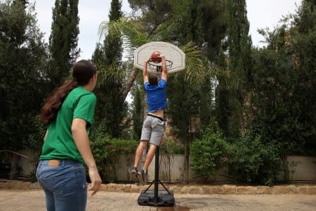 Greek and Turkish Cypriots young players called PeacePlayers Cyprus participate in a basketball event organised by EBRD inside the UN-controlled buffer zone in Nicosia, Cyprus May 9, 2017. REUTERS/Yiannis Kourtoglou