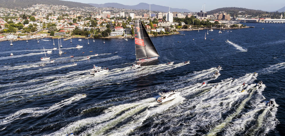 In this photo provided by Rolex/Studio Borlenghi, supermaxi Wild Oats XI, center, arrives in Hobart, Australia, to win the line honors in the Sydney Hobart yacht race, Friday, Dec. 28, 2018. (Carlo Borlenghi/Rolex/Studio Borlenghi via AP)