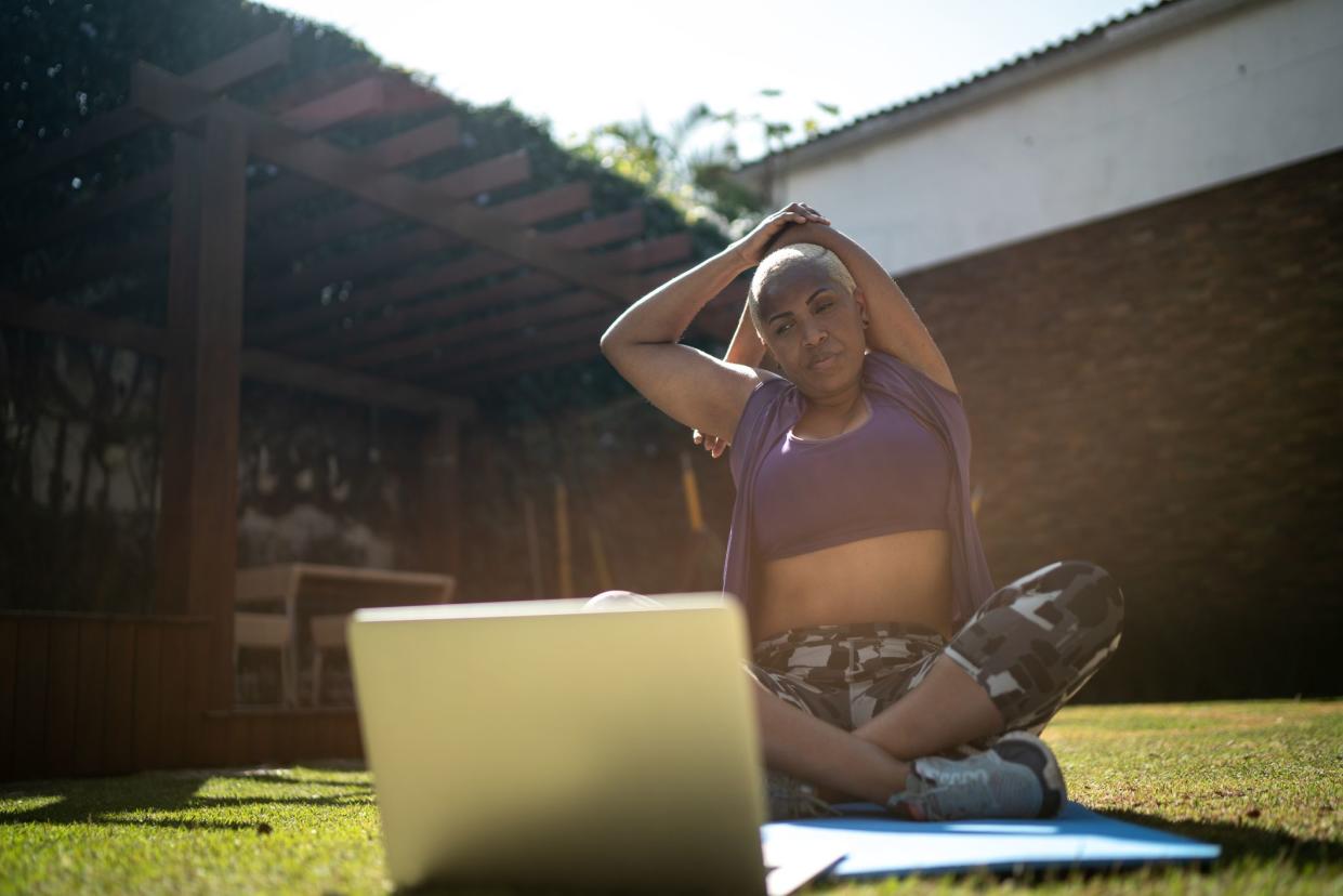 woman stretching for virtual exercise class