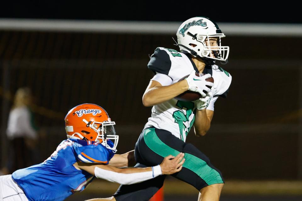 Dublin Coffman’s Cameron Hairston is tackled by Olentangy Orange's Treyton Schroeder during Orange's 35-14 home win Friday.