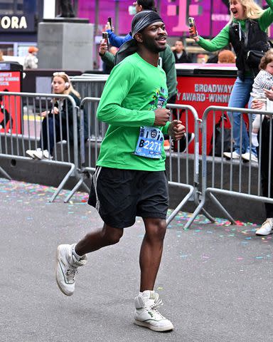 <p>Roy Rochlin/New York Road Runners via Getty</p> Lil Nas X wore Coach high-top sneakers for the race