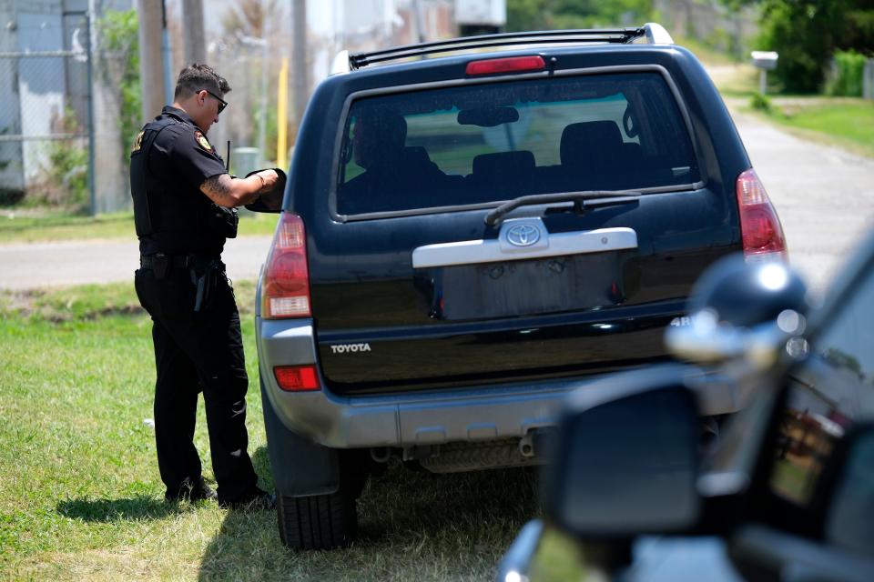 Muscogee Nation Lighthorse Police Officer Daryl Wilson checks out paperwork for a vehicle he pulled over July 3 that did not have a tag.