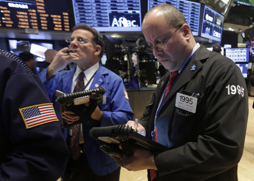 Traders Sal Suarino, left, and Jeffrey Vazquez work on the floor of the New York Stock Exchange, Wednesday, Feb. 26, 2014. The stock market is little changed as investors pick over more earnings reports from retailers and other U.S. companies. (AP Photo/Richard Drew)