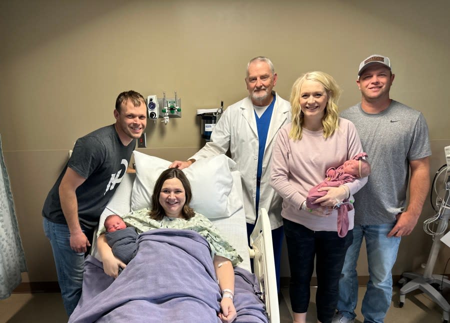 (From left to right) Brent and Callie Lehman hold their newborn while Dr. David Hodgson stands at center next to Andrea and Jeff with their own newborn.