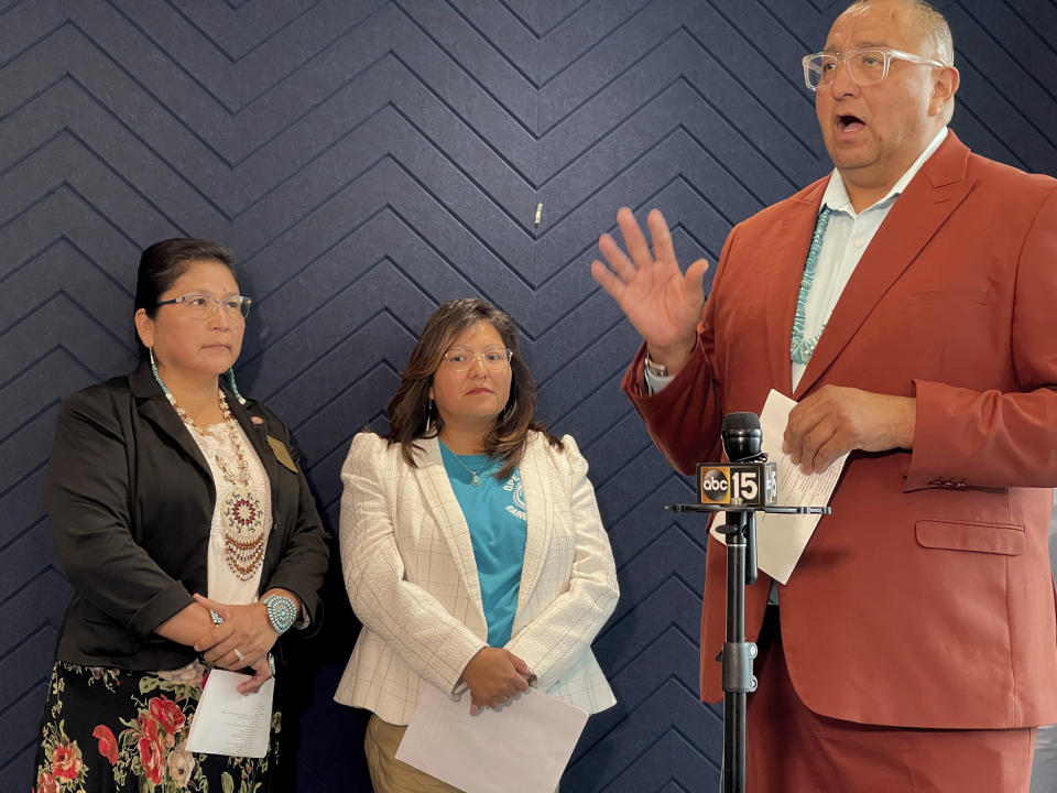 Thomas Cody, executive director of the Navajo Nation Division of Social Services, talks during a news conference in Phoenix on Friday, May 19, 2023. Cody explained what tribal leaders are doing to find and get care for members now being displaced by scores of illegitimate sober living homes that are under investigation for Medicaid fraud by the Arizona Attorney General's Office. Behind him are Arizona State Sen. Theresa Hatathlie, left, and Rhonda Tuni, right, the executive director of the Navajo Department of Health. (AP Photo/Anita Snow)