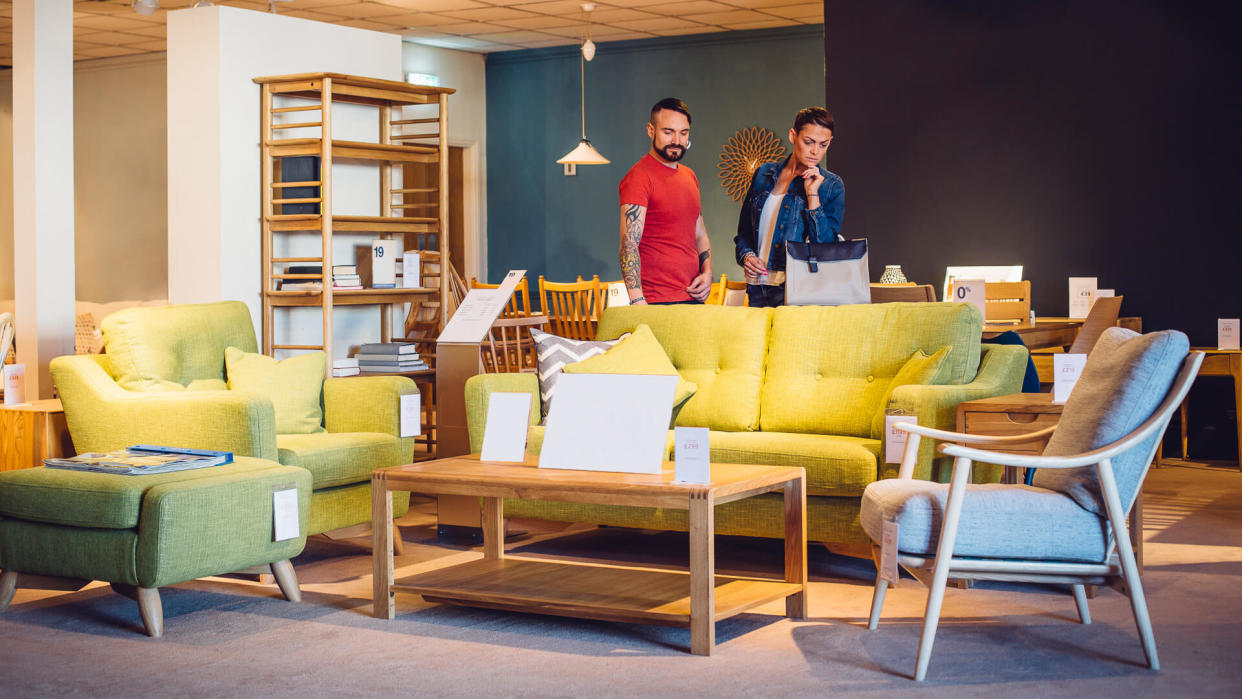 A middle aged couple are shopping in a furniture store for items for their new home.