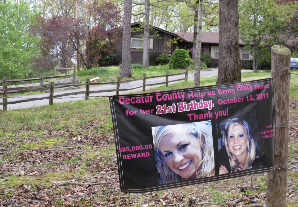 FILE - In this April 19, 2013 file photo, a poster with pictures of missing Tennessee nursing student Holly Bobo hangs on a fence in front of her house in Parsons, Tenn. Court documents show that Jason Autry, the star trial witness in the killing of Holly Bobo, a 20-year-old nursing student who disappeared from her rural Tennessee home in 2011, is recanting his testimony. (AP Photos/Adrian Sainz, File)