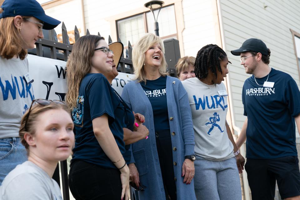 Washburn University president JuliAnn Mazachek laughs Thursday with student move-in crew members at The Villages. Mazachek went to the various residences around campus to talk with students and staff for her first move-in day in as president.