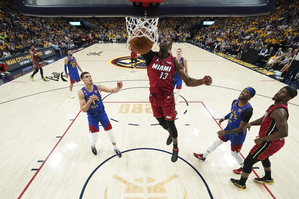 Miami Heat center Bam Adebayo (13) dunks against the Denver Nuggets during the second half of Game 1 of basketball's NBA Finals, Thursday, June 1, 2023, in Denver. (Kyle Terada/Pool Photo via AP)