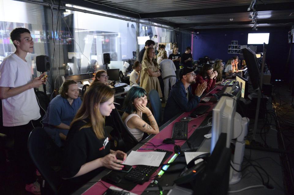 FILE - Journalists work in a news room of the Dozhd (Rain) TV channel in Moscow, Russia, Friday, Aug. 20, 2021. In 2014, Russian cable networks dropped Dozhd, the county's sole independent TV channel, after it hosted a history program on the 1941-44 Siege of Leningrad and asked viewers to vote on whether Soviet authorities should have surrendered Leningrad to save lives. The question caused an uproar, with officials accusing the channel of crossing moral and ethical lines and calling for its shutdown. (AP Photo/Denis Kaminev, File)