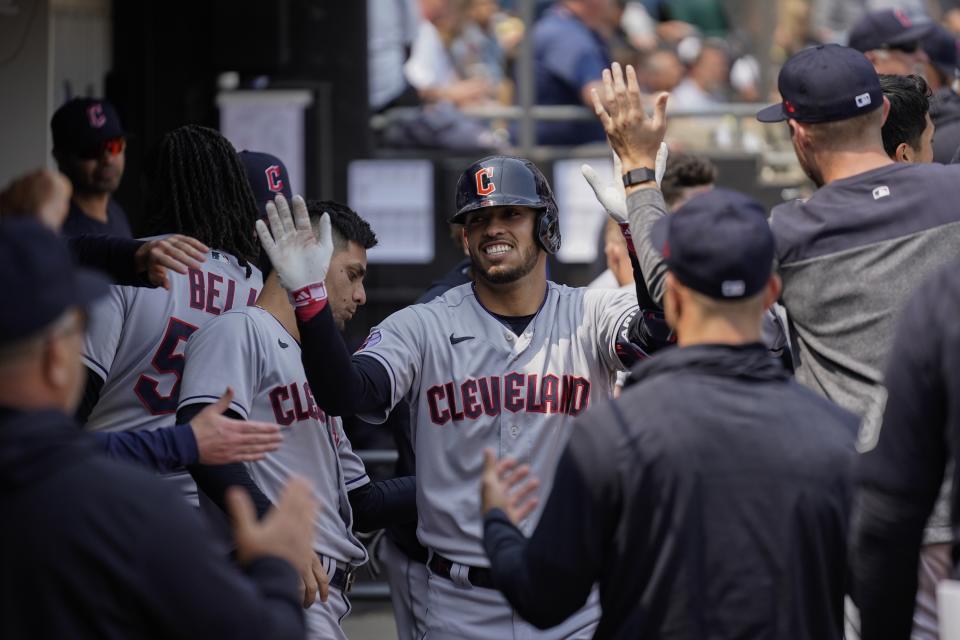 Cleveland Guardian' Gabriel Arias gets high-fives in the dugout after hitting a home run during the fifth inning of a baseball game against the Chicago White Sox, Thursday, May 18, 2023, in Chicago. (AP Photo/Erin Hooley)