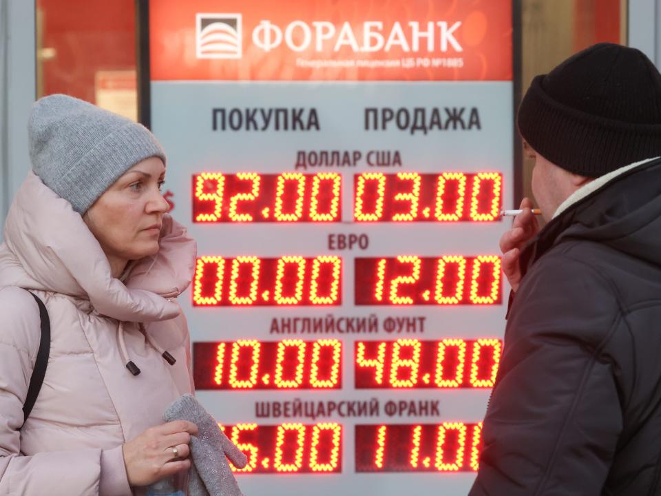 A digital board shows the exchange rate of the rouble against the US dollar and euro in Moscow, Russia.