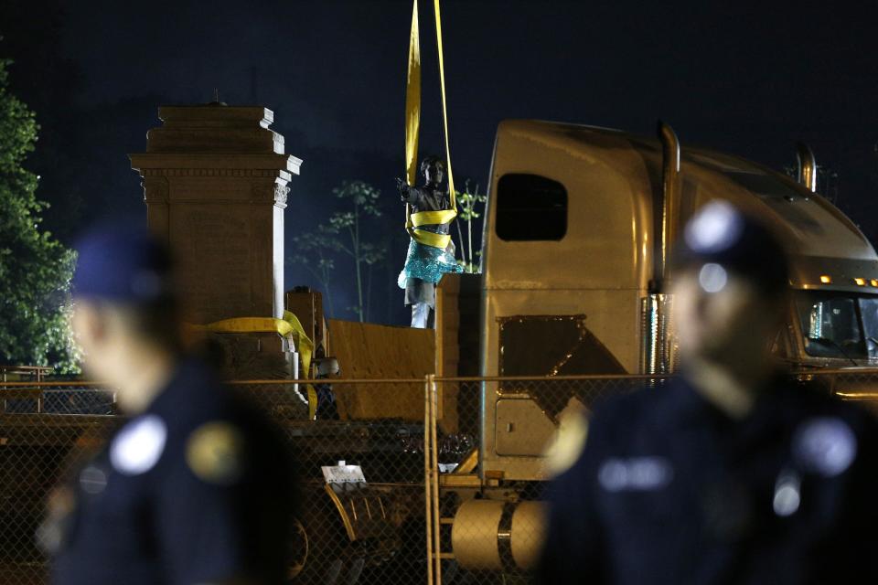 <p>New Orleans police officers stand guard as a monument of Jefferson Davis is removed in New Orleans on May 11, 2017. (Photo: Jonathan Bachman/Reuters) </p>