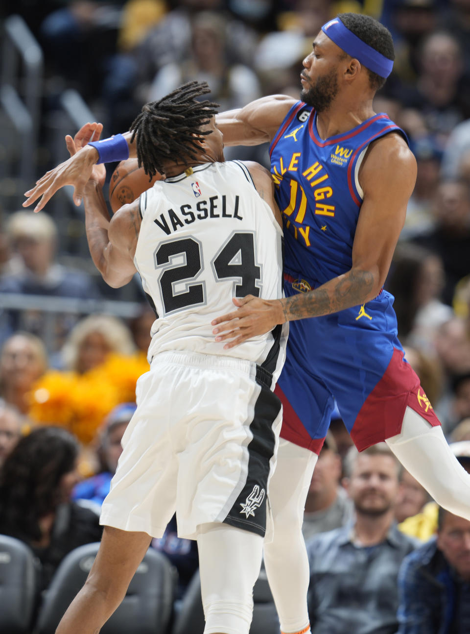 Denver Nuggets forward Bruce Brown, right, blocks a shot by San Antonio Spurs guard Devin Vassell in the second half of an NBA basketball game Saturday, Nov. 5, 2022, in Denver. (AP Photo/David Zalubowski)