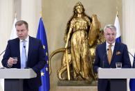 Finland's Defence Minister Antti Kaikkonen, left, and Foreign Minister Pekka Haavisto attend the press conference on Finland's security policy decisions at the Presidential Palace in Helsinki, Finland, Sunday May 15, 2022. Finland’s president and government have announced that the Nordic country intends to apply for membership in NATO, paving the way for the 30-member Western military alliance to expand amid Russia’s war in Ukraine. (Heikki Saukkomaa/Lehtiuva via AP)