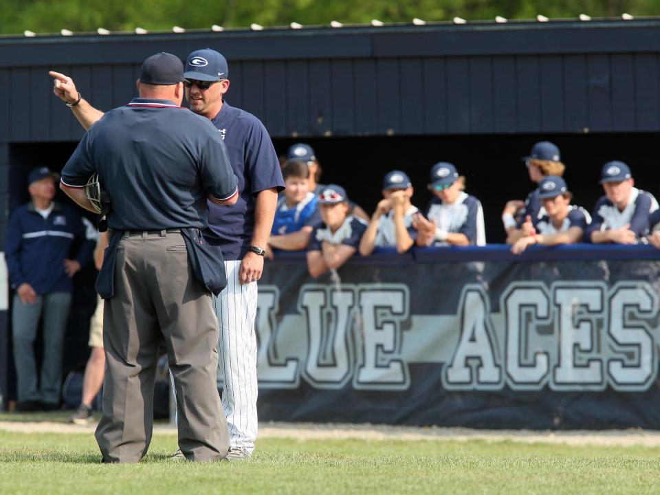 Granville coach Justin Richards has a discussion with the home plate umpire Thursday during the Blue Aces' 7-3 loss to Lakewood.
