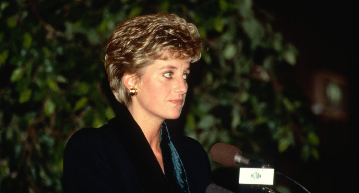 Princess Diana wore a distinctive green suit with a velvet collar designed by Amanda Wakeley during a speech announcing her resignation from public duties at the Hilton Hotel in December, 1993 in London. (Getty Images)