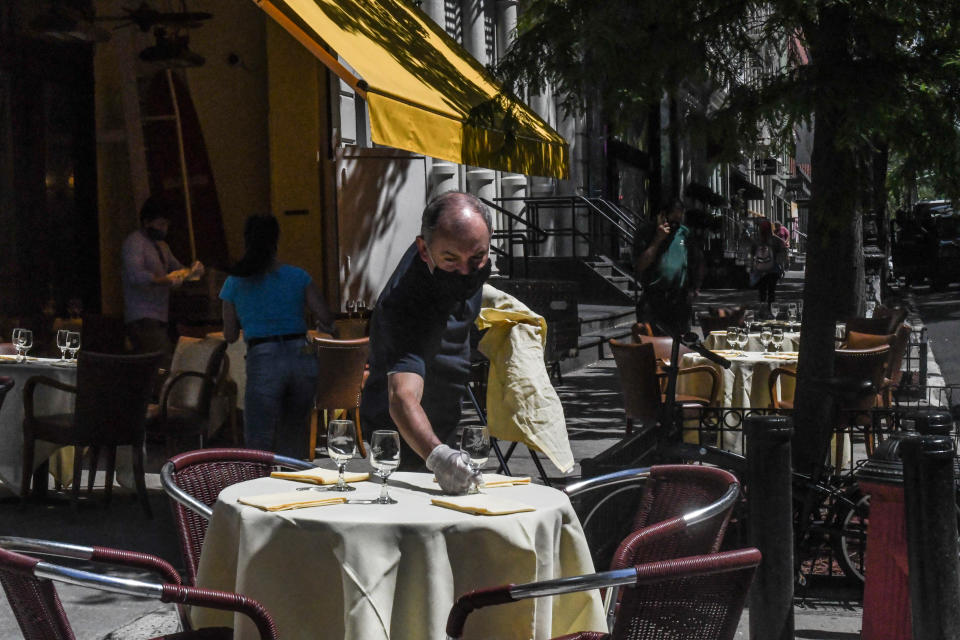 NEW YORK, NY - JUNE 22: A worker sets an outdoor table for the Cipriani restaurant on June 22, 2020 in the SoHo neighborhood in New York City. New York City enters phase 2 reopening with the reopening of retails stores, outdoor dining and barbershops. The city estimates as many as 400,000 people will return to work next month as coronavirus restrictions are lifted. (Photo by Stephanie Keith/Getty Images)