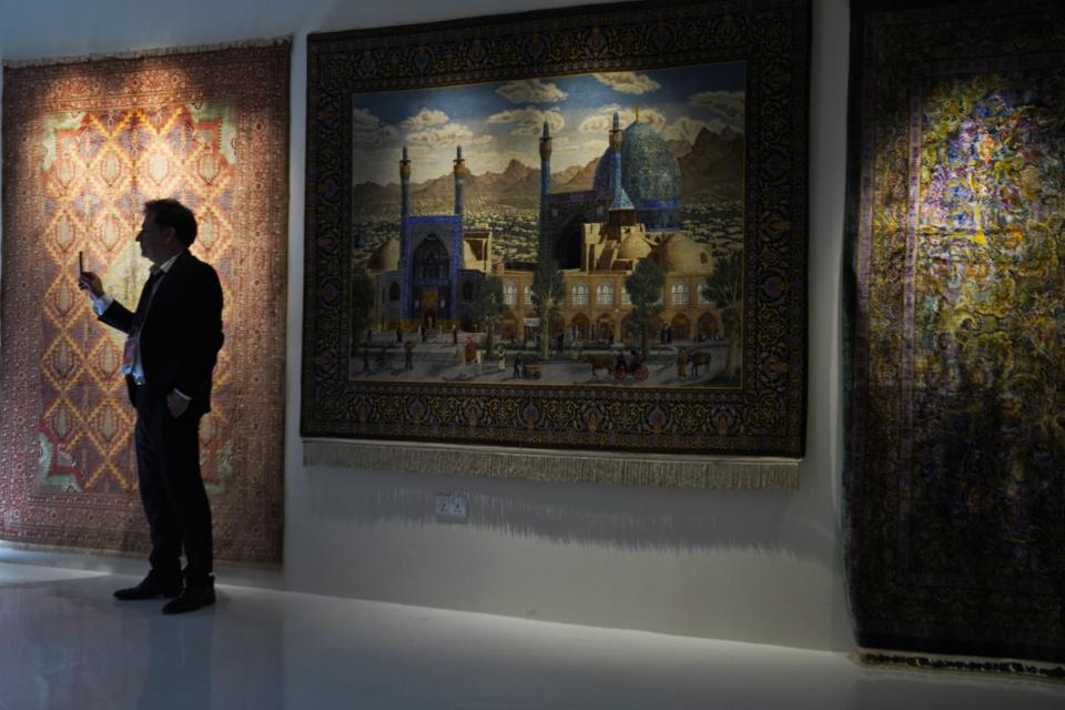 A man takes a photo of an area of Iran's pavilion at Expo 2020 in Dubai, United Arab Emirates, Saturday, Oct. 2, 2021. Dubai has gambled billions to make the gleaming, built-from-scratch Expo village a triumphant tourist attraction and symbol of the United Arab Emirates itself — a feast for the eyes devoid of politics and built on the promise of globalization. But even as nations use their pavilions for benign infomercials, the political turbulence of the wider world somehow manages to intrude. (AP Photo/Jon Gambrell)