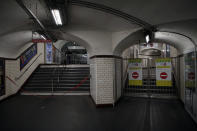 Signs close access in a subway, in Paris, Sunday, Dec. 8, 2019 on the fourth day of nationwide strikes that disrupted weekend travel around France. (AP Photo/Francois Mori)