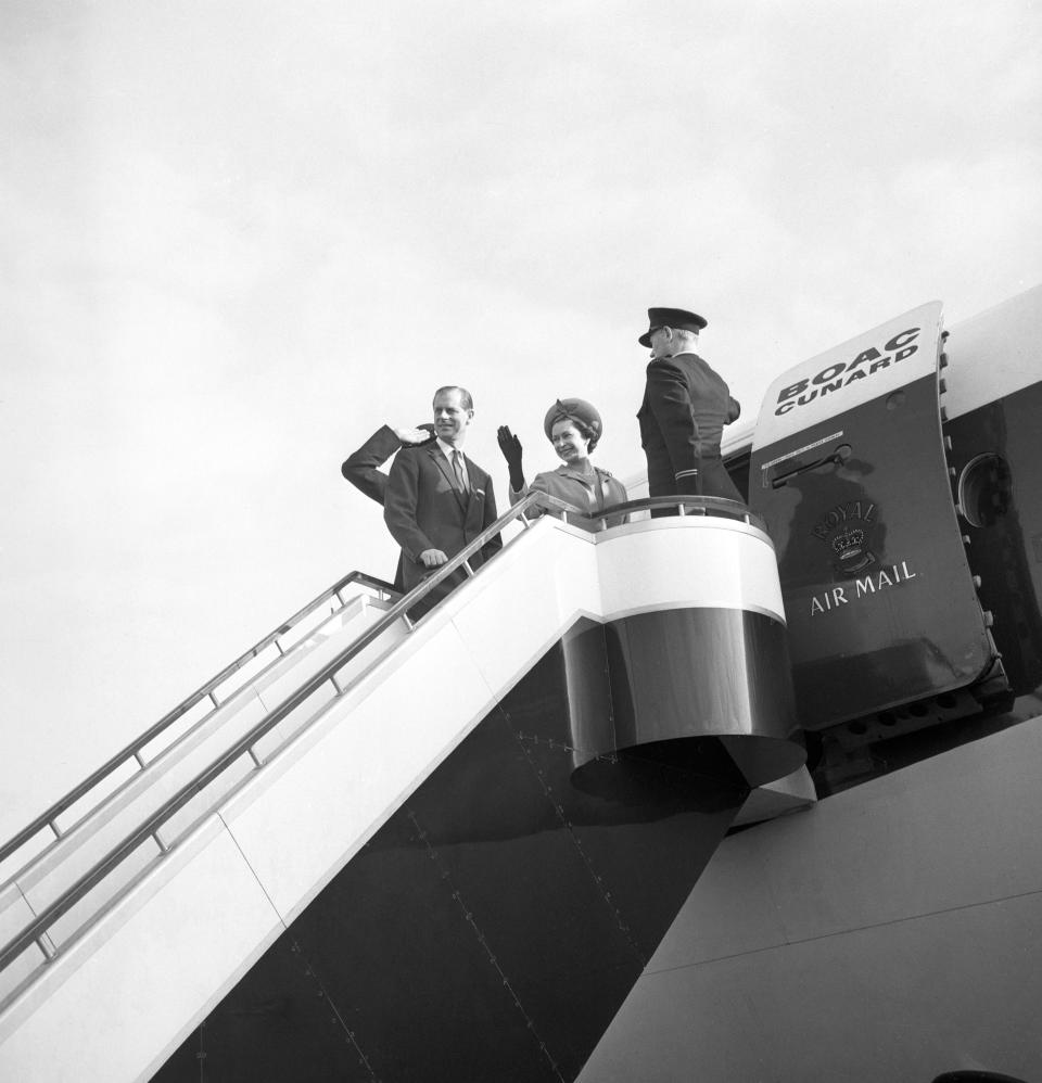 Queen Elizabeth II and the Duke of Edinburgh on the top of the steps as they board a BOAC Super VC 10 liner at London Airport to fly to Barbados at the start of a Caribbean tour. The journey had been delayed for 25 minutes while security men searched the aircraft for a bomb following an anonymous telephone call.