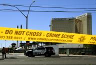 <p>Crime scene tape surrounds the Mandalay Hotel (background with shooters window damage top right) after a gunman killed dozens of people and wounded hundreds when he opened fire on a country music concert in Las Vegas, Nev. on Oct. 2, 2017. (Photo: Mark Ralston/AFP/Getty Images) </p>