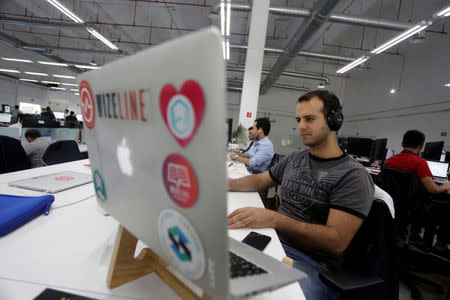 Employees of San Francisco-based software company Wizeline, work at the company's offices in Guadalajara, Mexico October 5, 2017. Picture taken October 5, 2017. REUTERS/Daniel Becerril