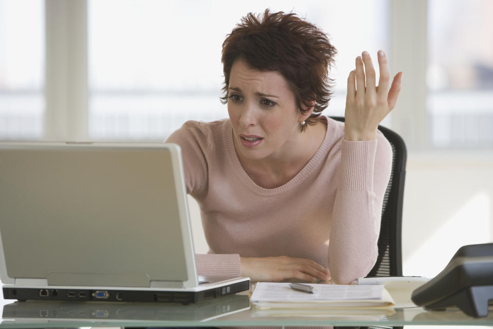 Frustrated businesswoman looking at laptop
