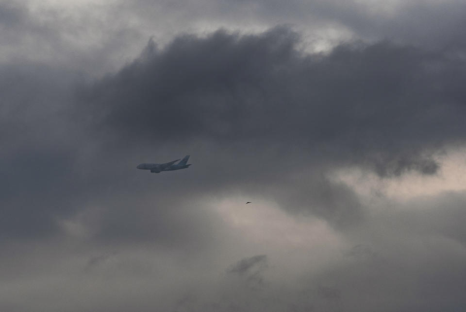 A Korean Airlines jet plane approaches Los Angeles International Airport as low clouds gather over the Pacific ahead of forecasted rain in Los Angeles, Sunday, Feb. 18, 2024. (AP Photo/Damian Dovarganes)