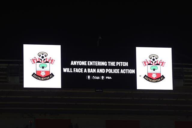 The large stadium screen saying Anyone Entering The Pitch Will Face A Ban And Police Action’ at St Mary's