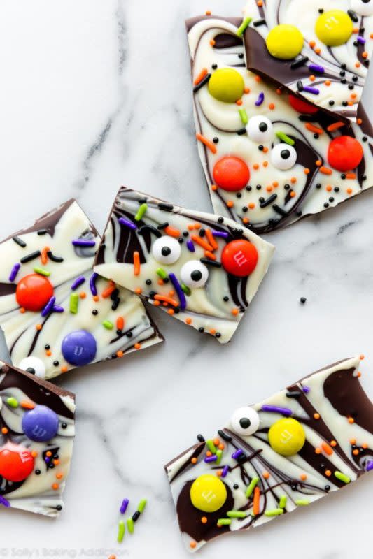 <p>Boo mark is equal parts high quality baking chocolate and your favorite trick-or-treat candy. </p><p><strong>Get the recipe:</strong> <a href="https://sallysbakingaddiction.com/easy-halloween-recipes/" rel="nofollow noopener" target="_blank" data-ylk="slk:Boo Bark – Halloween Chocolate Bark;elm:context_link;itc:0;sec:content-canvas" class="link ">Boo Bark – Halloween Chocolate Bark</a></p>